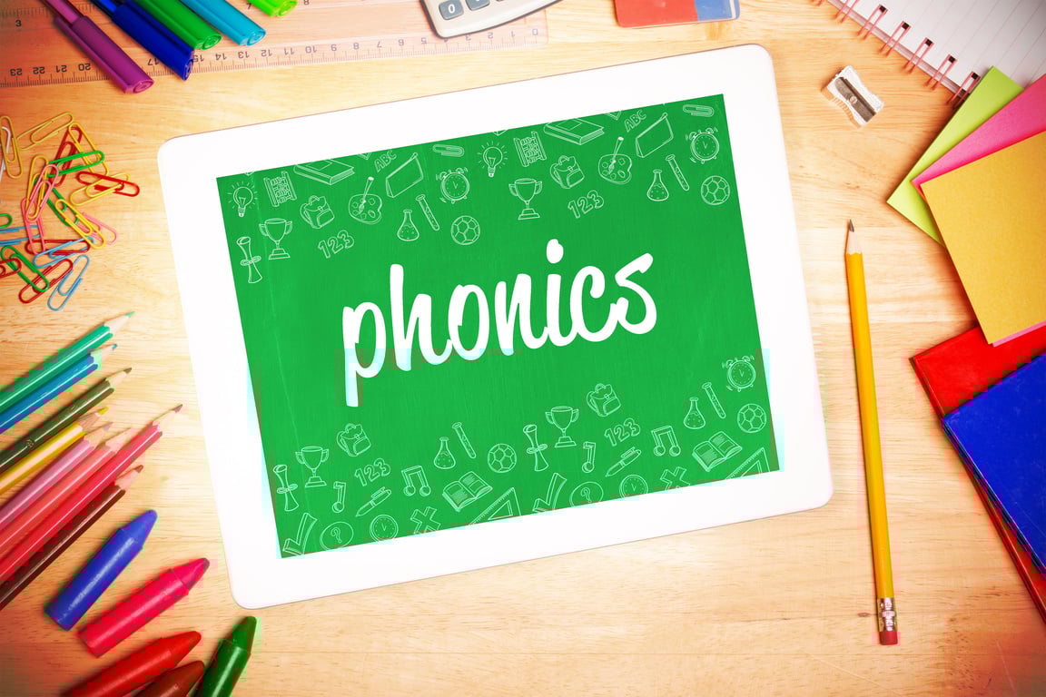 Phonics against students desk with tablet pc